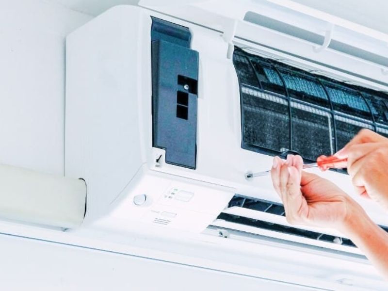 AC installation technician mounting split AC unit in Dammam